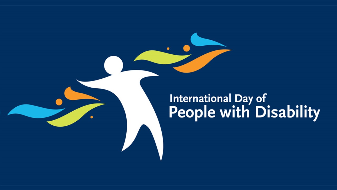 White person figure against a navy blue background with orange, blue and green shapes on either side. Text reads ‘International Day of People with Disability.'
