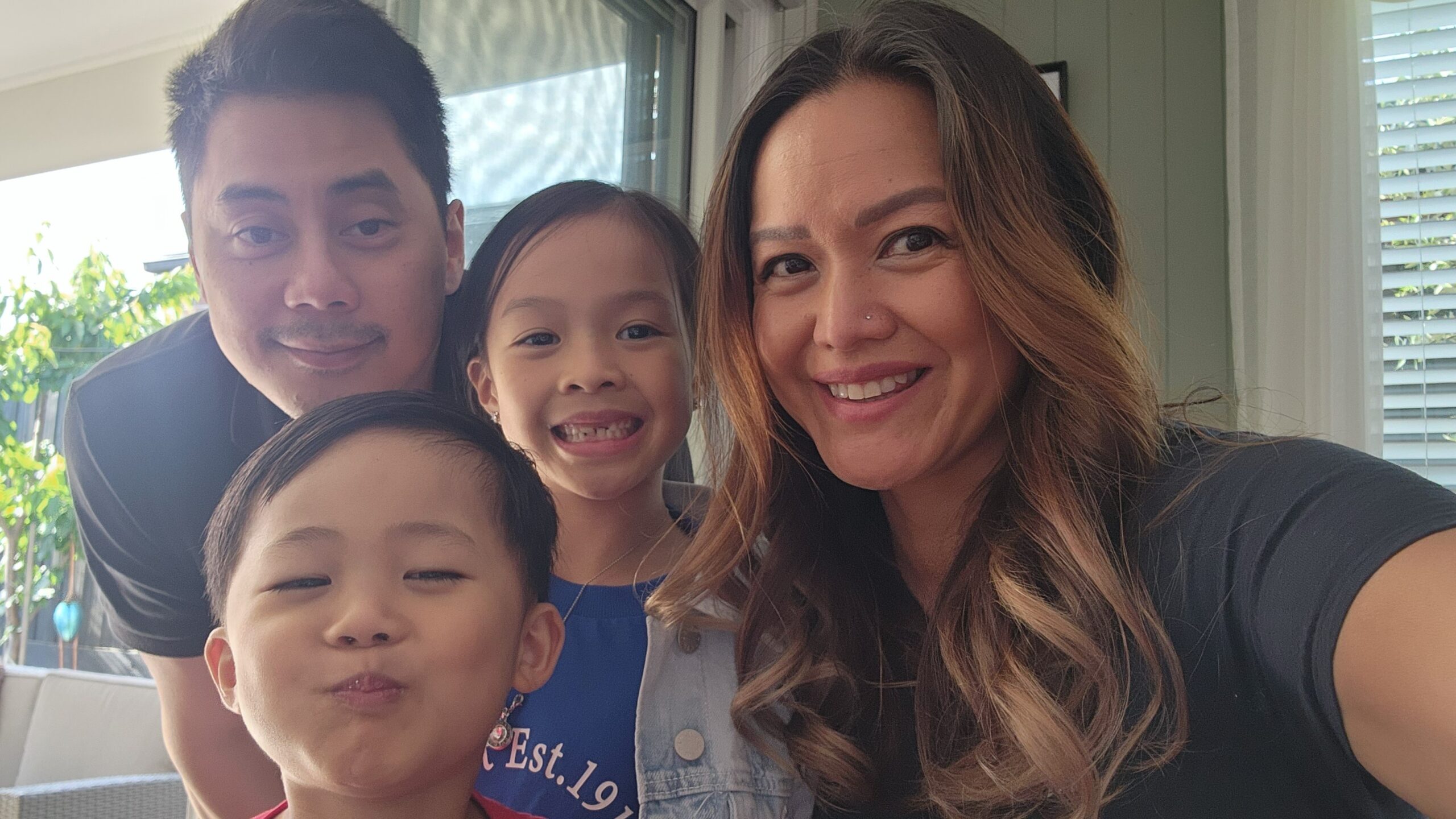 Five-year-old Isaac poses with his family for a selfie.