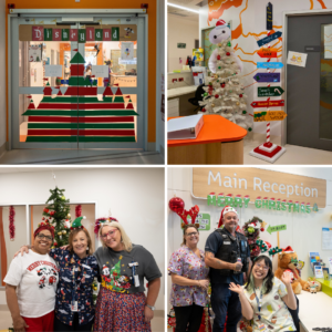 Staff at a hospital wearing festive headbands and clothing smile by Christmas decorations for photos.