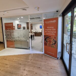 The glass frontage of an office, the door wide open inviting people to enter. 