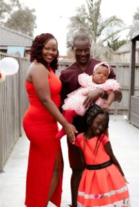 A young family of four smartly dressed for a special occasion.