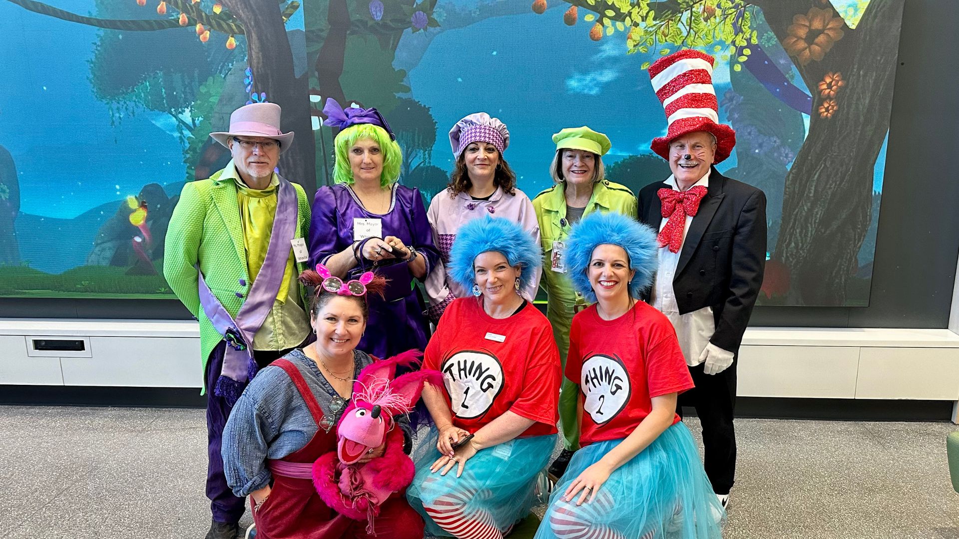 Eight adults dressed as characters from Dr. Seuss' children's books.
