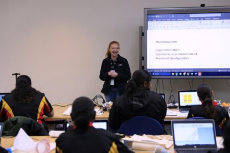Photo of Kerry Strickland talking to students in front of a group of students