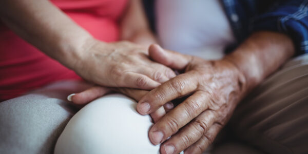 Mid-section of senior couple holding hands Mid-section of senior couple holding hands at home
